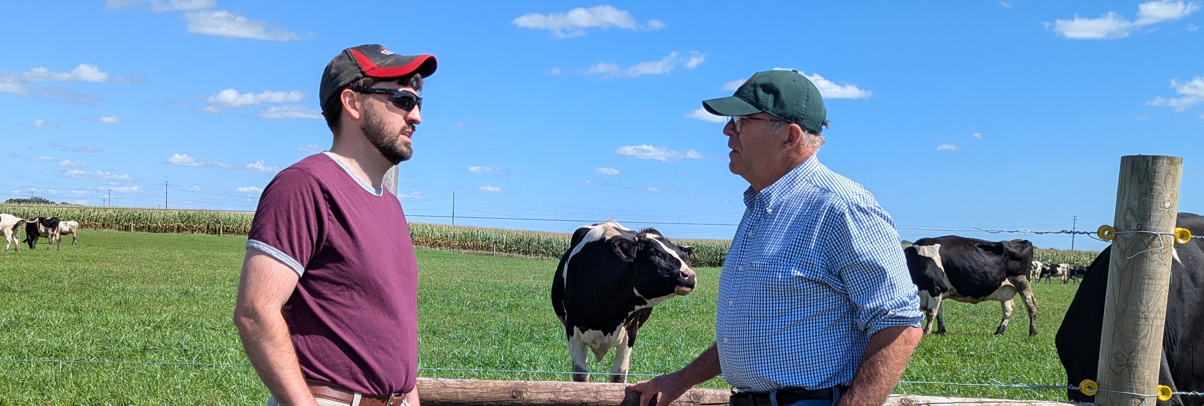 Ben Wieman talking with a neighbor on the farm — the kind of honest, face-to-face conversation we're bringing to the Fish Fry Townhall